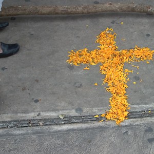 Marigold petals form a cross in front of an altar in Merida's Plaza Grande. <a href=></a>