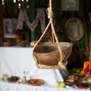 Gourds are used for many things. This one hangs in front of a Hanal Pixán altar... but has nothing in it! <a href=></a>