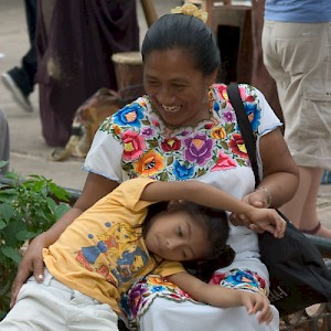 A Mayan woman and her daughter playing in the park. <a href=></a>