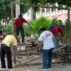 Men from a village tearing down an altar in Merida's Plaza Grande to take it home. <a href=></a>