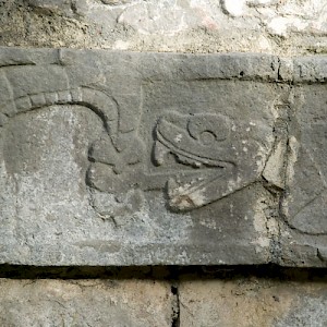 A bas-relief sculpture of a rattle snake eating its tail. <a href=></a>