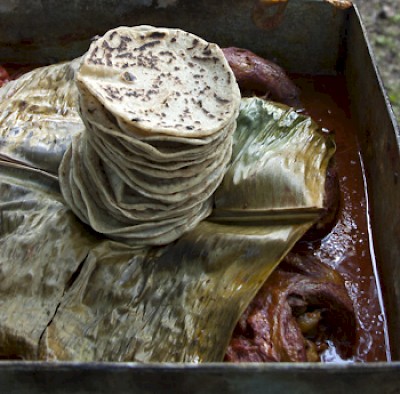Tortillas top a big pan full of delicious cochinita... <a href=></a>